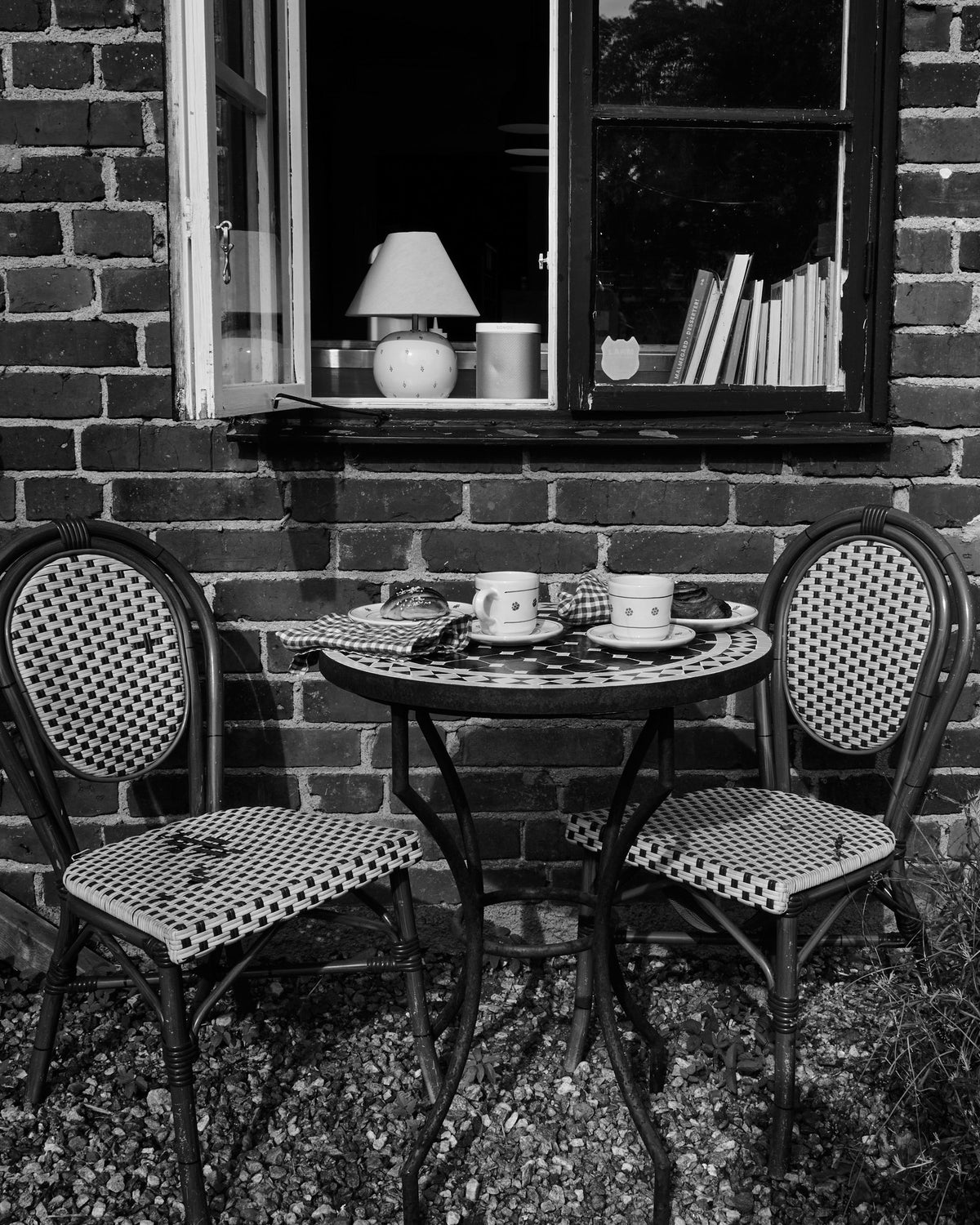 Bistro table and mosaic table by the brick wall